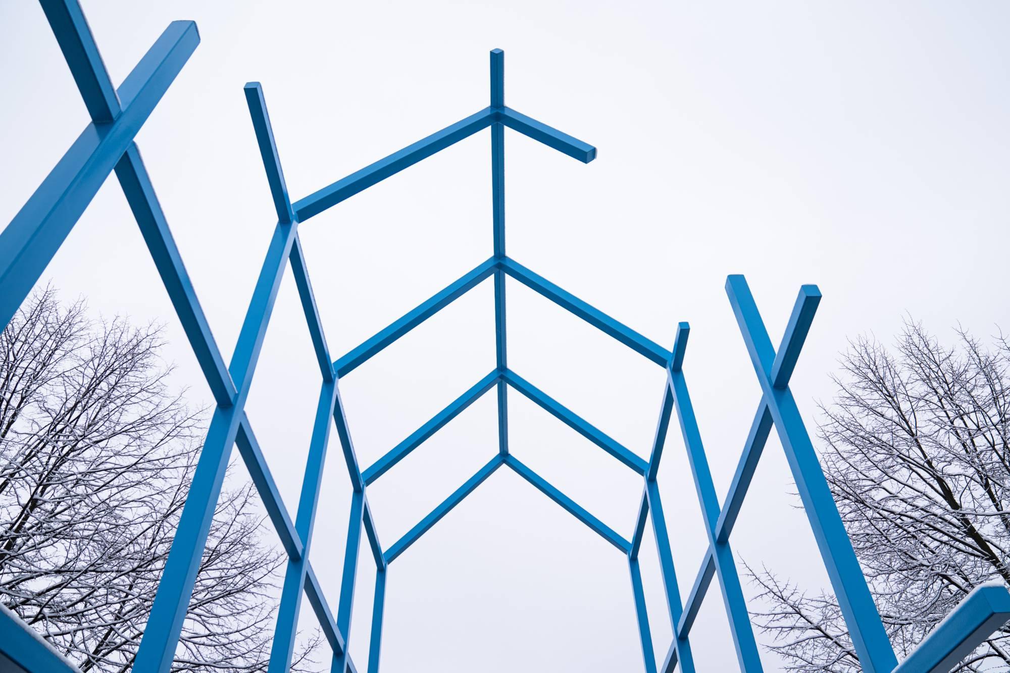 The blue Transformational Link on GVSU's Allendale Campus in the winter with snow on the trees